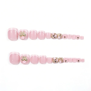 Pink French square press-on toenails with bows, rhinestones, and flowers on white background