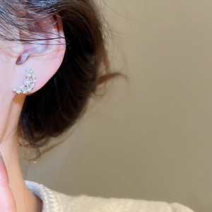 Elegant gold-plated moon earrings with pearls and zircons worn by a model
