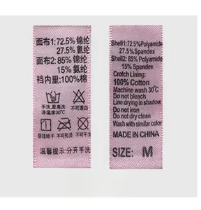 Detail view of pink lace underwear wash label with fabric composition and size info