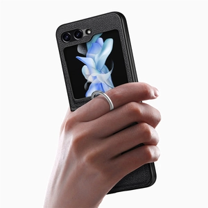 Detail of black leather texture phone case with silver ring holder for folding phone