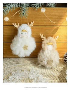 Detailed view of plush Christmas angel ornaments with reindeer antlers on wooden tray