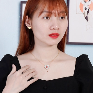 Golden heart necklace and stud earring set featuring red crystal gemstone and tiny diamonds