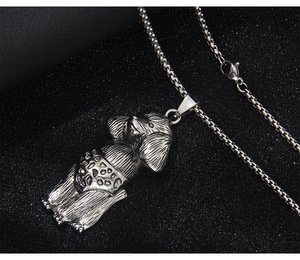 Detail view of a silver poodle pendant with leopard print shorts on a box chain