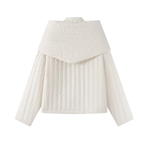 Detailed view of vertical quilted texture and large collar on white puffer jacket