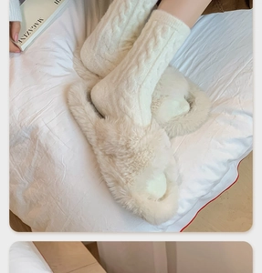 Close-up of white cable knit warm socks paired with fluffy plush indoor slippers on a bed