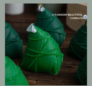 Macro detail of a zongzi-shaped green scented candle with intricate wax textures