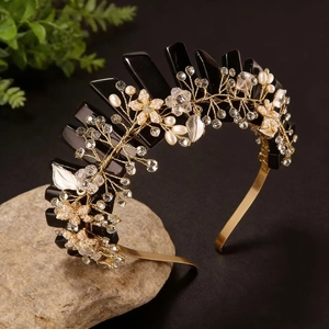 Detail of handmade crown headband with pink crystals and pearls on a natural stone