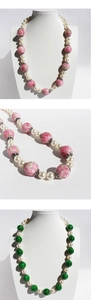 Detail of pink and green glass beads with pearls and silver spacers on a model bust