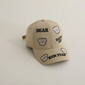 Close-up of premium khaki cotton baseball cap featuring detailed cute bear embroidery