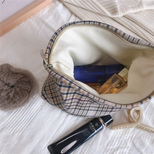 Macro detail of plaid makeup bag with thick canvas lining and premium cosmetics