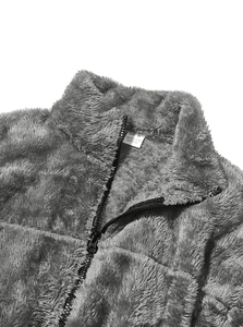 Detail of soft fleece fabric texture with zipper and material label showing 95% polyester