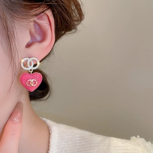 Detail of pink strawberry earrings with gold double-ring design and sparkling zircons