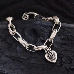 Vintage S925 silver bracelet featuring crown and heart pendants with green zircon stones