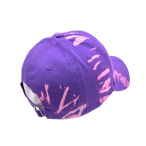 Detail view of tie-dye baseball cap back with adjustable metal buckle and pink lettering