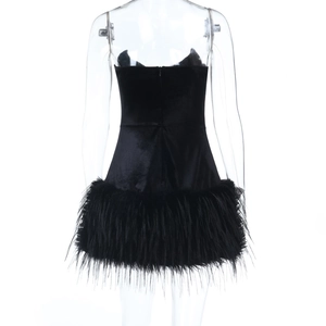 Detail view of black velvet mini dress featuring luxurious feather trim at the bottom hem