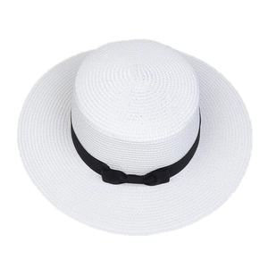 Top view of a white straw sun hat featuring a wide brim and elegant black ribbon bow