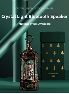 Detail of vintage Christmas lantern music box next to a premium green gift box