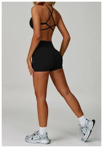 Detail of cross-back yoga top and high-waisted lifting shorts in premium black fabric