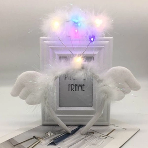 Detailed view of white feather angel halo headband with colorful LED lights and small wings