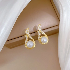 Detailed shot of pearl earrings with white zircons on a luxury jewelry box display