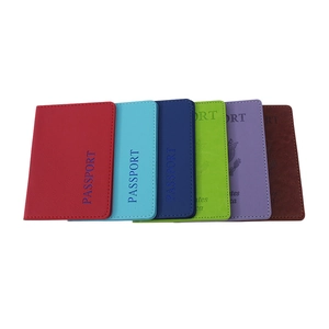 Fan-shaped arrangement of multi-colored PU leather passport holders on a white background