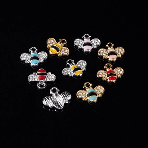 Detail of bee charms with enamel stripes and rhinestones in various color combinations
