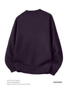 Detail of dark purple crewneck sweatshirt showing waffle texture knit and ribbed cuffs