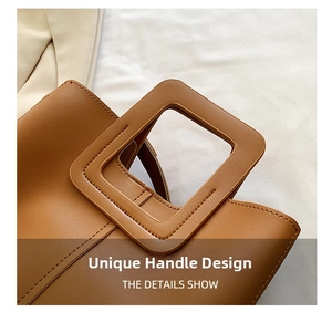 Detail of a brown leather bucket bag featuring a unique square handle and tonal stitching