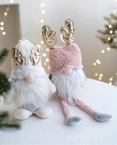 Detail of pink and white Christmas gnomes with golden antlers and fuzzy textures