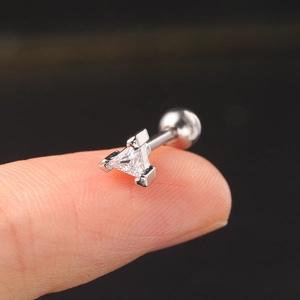 Detail of silver triangular zircon stud earring shown on fingertip with screw ball back