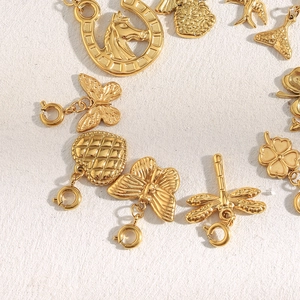 Detail of 18K gold plated stainless steel charms including clover and butterfly shapes