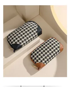 Detail view of houndstooth fabric texture and premium leather trim on stylish clutch bags