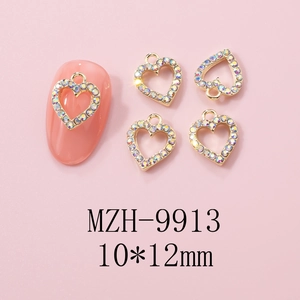 Macro view of gold heart nail charms with AB rhinestones for Y2K manicure art