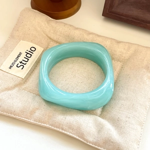 Modern marble texture square resin bangle in light blue on soft linen dust bag
