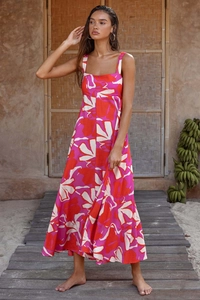 Outdoor shot of a tropical floral maxi dress with abstract print and spaghetti straps