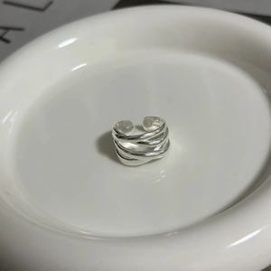 Detail of silver multi-layered adjustable onyx ring on white ceramic plate