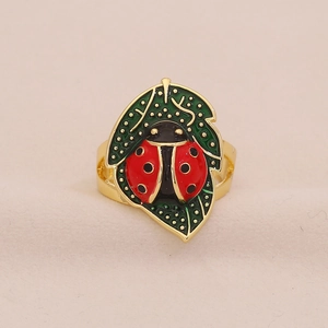 Charming ladybug on green leaf ring with vibrant red enamel and golden finish