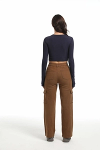 Detail view of stylish women's high-waist cargo pants with multi-pockets and draped fit