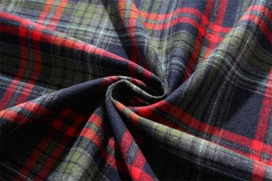Close-up of red and green plaid festive tablecloth fabric with soft flannel texture