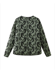 Detail of green quilted jacket featuring vintage ethnic print and diamond stitching