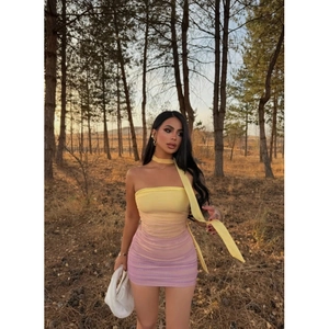 Detail of gradient tube dress featuring yellow to pink transition and ruched fabric texture