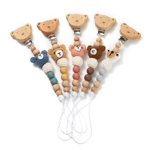 Baby pacifier clips with crochet bears and wooden beads in five soft pastel colors