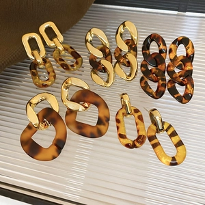 Detailed set of leopard print earrings with gold chains and tortoiseshell resin details