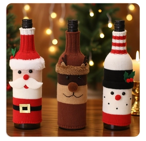Detailed view of three knitted Christmas wine bottle covers with Santa, Elk, and Snowman