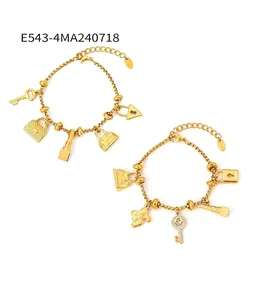 Detailed macro of 18K gold plated stainless steel bracelet with mixed charms