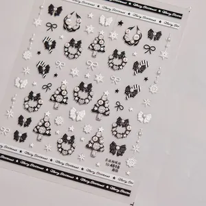 Stickers ongles Noël chic avec nœuds noir et blanc, flocons de neige et strass brillants