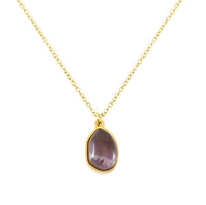 Macro detail of irregular purple crystal pendant with gold plating on stainless steel chain