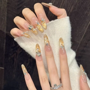 Cat eye press-on nails with gold glitter, rhinestones, and silver crown ring detail
