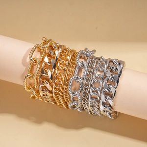 Four-piece set of gold and silver chunky chain bracelets with punk metal aesthetic