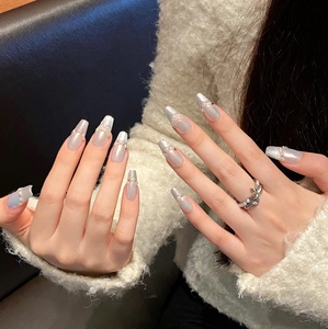 Macro detail of silver cat-eye press-on nails with luxury pearls and rhinestone accents